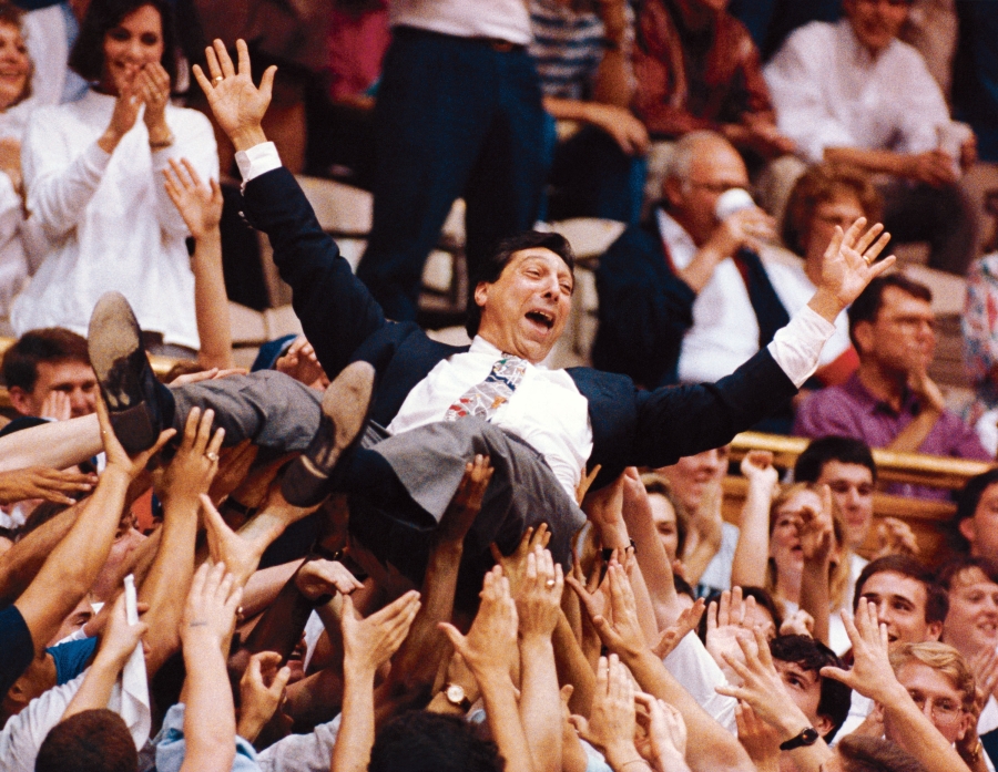 Jim Valvano, or Jimmy V, is shown crowd surfing through a sea of fans. (Unknown)