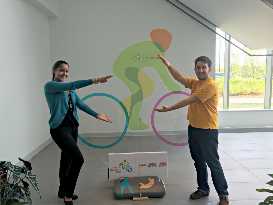 Eneisy Rodriguez and Miguel Machado doing the Florida Gator "chomp" in front of a Pan Am Games sign on ESPNâ€™s Bristol, Conn. campus. (Kyle Van Fechtmann/ESPN)