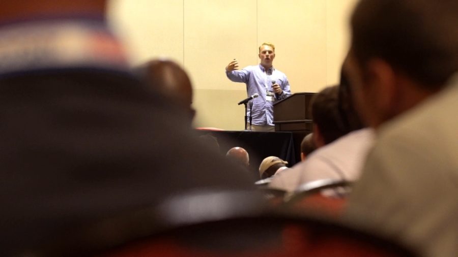 Former UConn quarterback Casey Cochran speaks at a coachesâ€™ conference about taking concussion precautions.